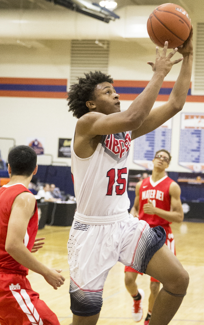 Liberty’s Cameron Burist (15) drives past Mater Dei defenders during the Tarkanian Cla ...