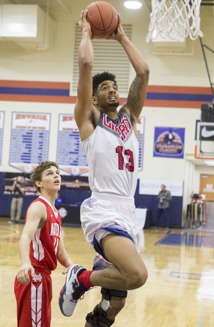 Liberty’s Dyllan Robinson (13) converts a fast break layup during the Tarkanian Classi ...
