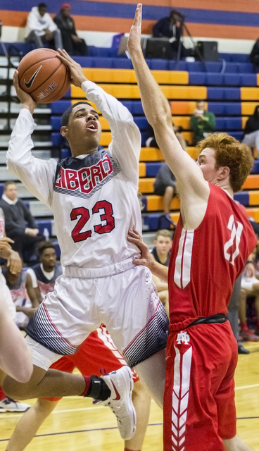 Liberty’s Julian Strawther (23) shoots over Mater Dei’s Matthew Weyand (21) duri ...