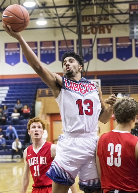 Liberty’s Dyllan Robinson (13) shoots over Mater Dei’s Reagan Lundeen (33) durin ...