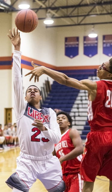 Liberty’s Julian Strawther (23) drives past Mater Dei’s Miles Brookin (20) durin ...