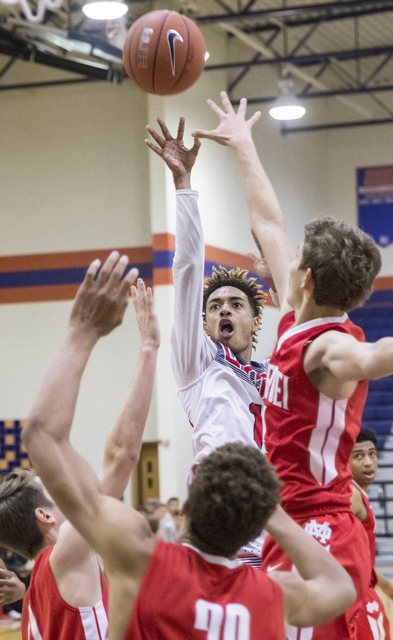 Liberty’s Jordan Holt (10) shoots over a group of Mater Dei defenders during the Tarka ...