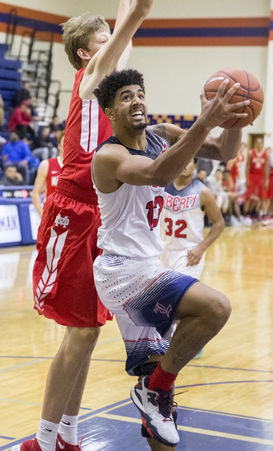 Liberty’s Dyllan Robinson (13) converts a fast break layup during the Tarkanian Classi ...