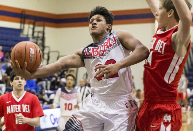 Liberty’s Damahny Whittle (32) drives past Mater Dei’s Aidan Prukop (14) during ...