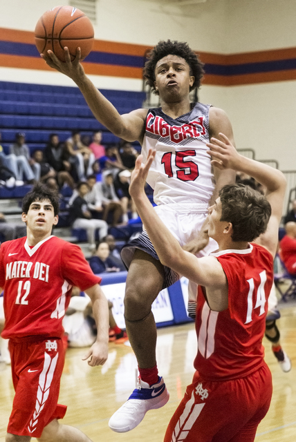 Liberty’s Cameron Burist (15) drives past Mater Dei’s Aidan Prukop (14) during t ...