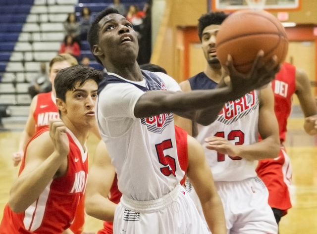 Liberty’s Daryl Finley (5) drives past Mater Dei defenders during the Tarkanian Classi ...