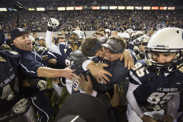 St. John Bosco’s head coach Jason Negro celebrates with his team after defeating De La ...