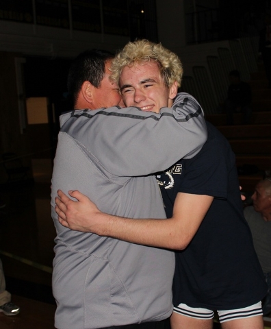 Shadow Ridge’s Brendt Burleson (right) is hugged by coach Gus Gledhill after Burleson ...