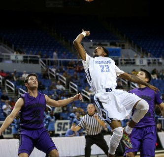 Canyon Springs’ Shaquille Carr shoots over Spanish Springs defender Hunter Pinto durin ...
