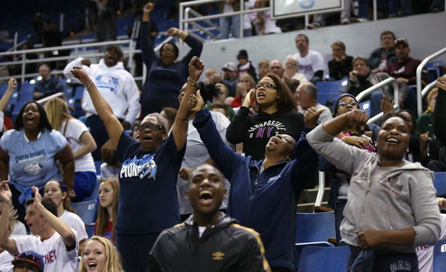 A group of Canyon Springs fans celebrate after the Pioneers defeated Spanish Springs 66-51 i ...