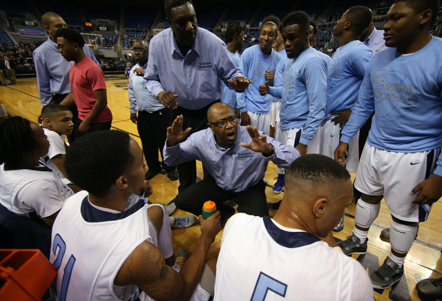 Canyon Springs head coach Freddie Banks talks to his team during a timeout during the team&# ...