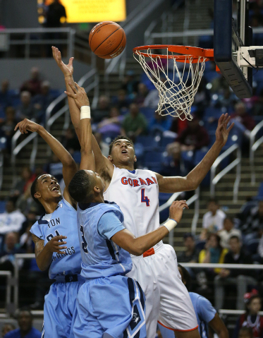 Bishop Gorman’s Chase Jeter seen shooting over Canyon Springs defenders Darrell McCall ...