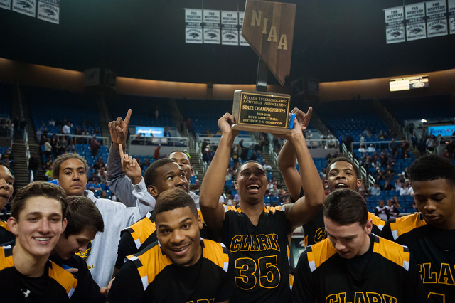 Clark players celebrate with the Division I-A state championship trophy after beating Elko 4 ...