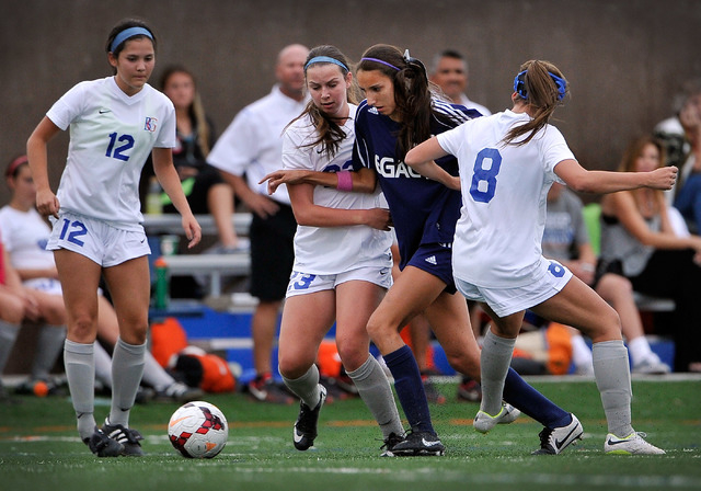 Legacy High School’s Nadia Hernandez, second right, is triple-teamed by Bishop Gorman& ...
