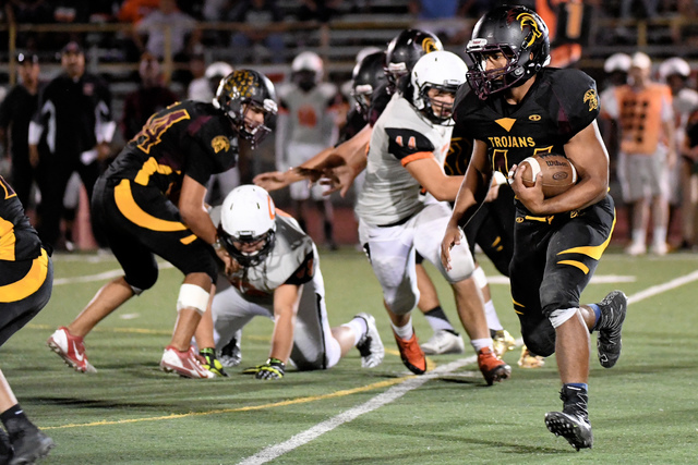Pahrump Valley’s Aaron Fuentes carries the ball against Chaparral on Friday, Sept. 16. ...