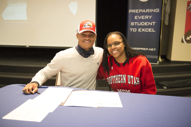 Agassi Prep’s Zeivaun Ned, left, poses after signing with Southern Utah to play footba ...