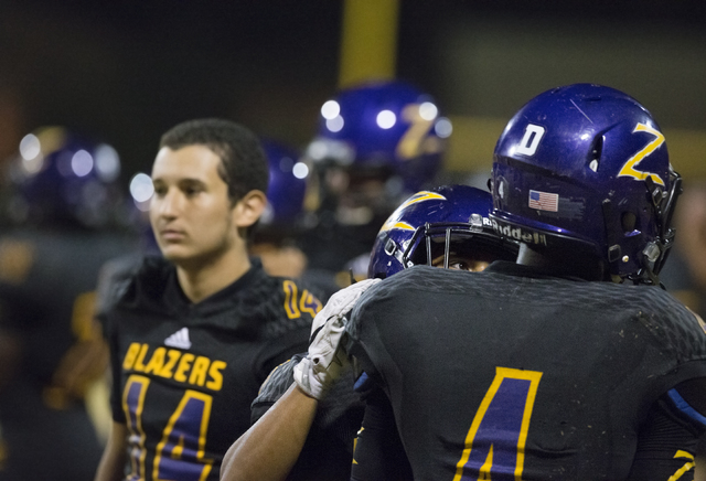 Durango running back Boogie Kamara (4) is consoled by teammates after the loss to Sierra Vis ...