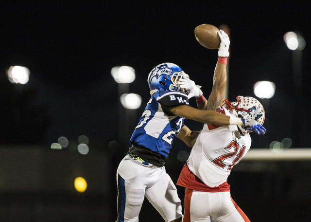 Liberty’s Darion Acohido (21) reaches over Basic’s Jordan Gallegos (25) to try a ...