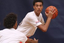 Greg Floyd, Jr., right, has possession of the ball and is guarded by Capri Uzan during a Las ...