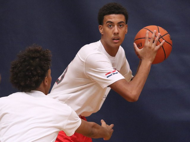 Greg Floyd, Jr., right, has possession of the ball and is guarded by Capri Uzan during a Las ...