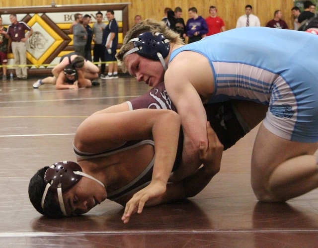 Defending regional and state champion Hunter Brown, of Centennial, works on top of Cimarron- ...