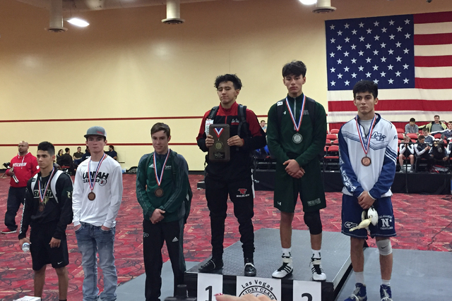 Las Vegas High’s Antonio Saldate (center) smiles as he is acknowledged as the champion ...