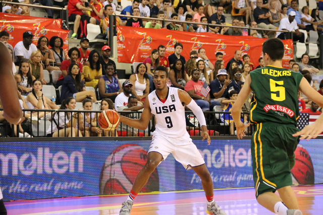 Centennial’s Troy Brown (#9) looks to pass to a teammate in a game against Lithuania o ...