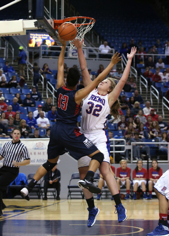 Reno’s Morgan McGwire blocks a shot by Liberty’s Aubre’ Fortner during the ...