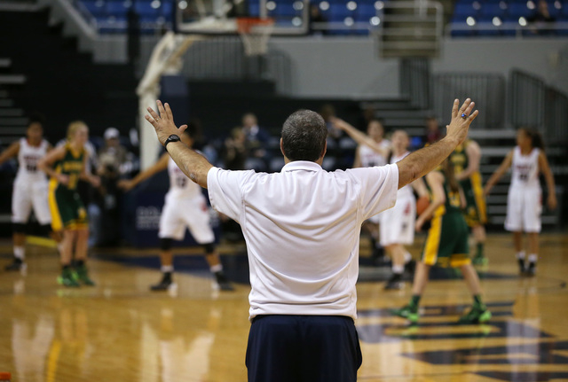 Liberty head coach Rich Santigate signals his players during a Division I state semifinal ga ...
