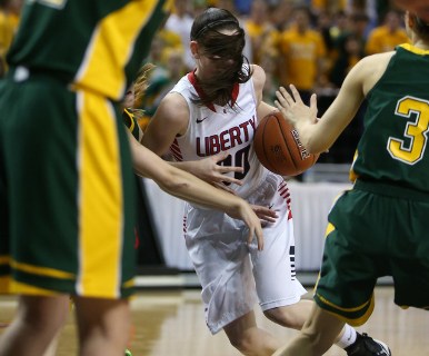 With her hair flying, Liberty’s Kealy Brown drives through a crowd of Bishop Manogue d ...