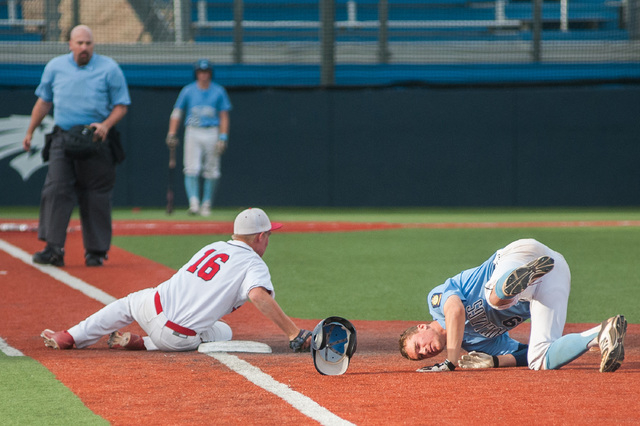 Liberty’s Justin Lutes collides with Centennial’s Jared Drizin at first base in ...
