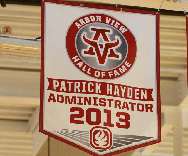 A banner honoring former principal Pat Hayden, at left, hangs in Arbor High School’s A ...
