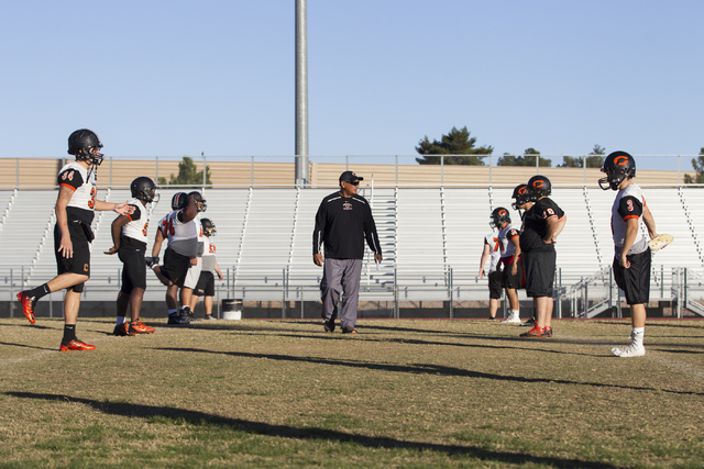 Chaparral head coach Paul Nihipali watches his players stretch during practice on Thursday, ...