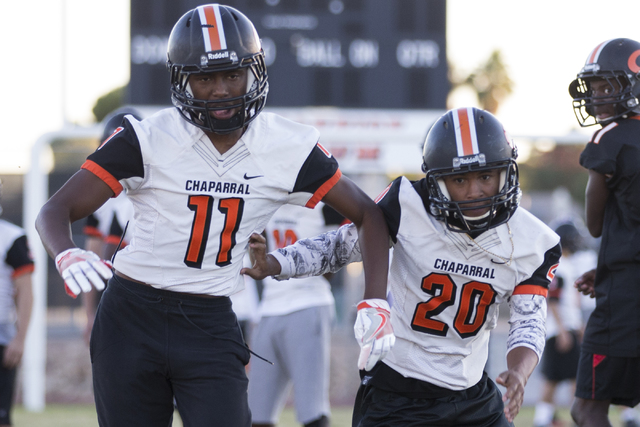 Chaparral’s Kentrell Petite (11) runs a pass drill with Dylan Disroe (20) during pract ...