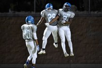 Canyon Springs’ Lazarus Kyle (7) celebrates with teammates after score a touchdown aga ...