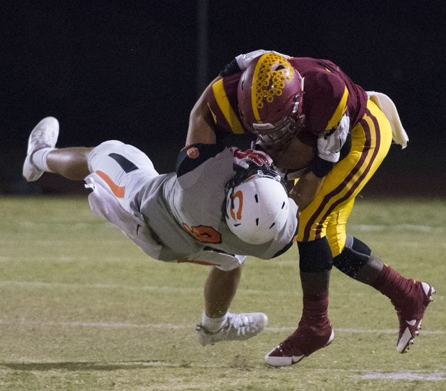 Del Sol’s Taariq Flowers (5) is tackled by Chaparral’s Devin Gaddy (9) during a ...