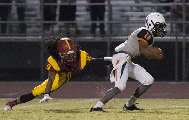 Chaparral’s Tyray Collins (19) runs past Del Sol’s Barry Williams jr. (9) during ...