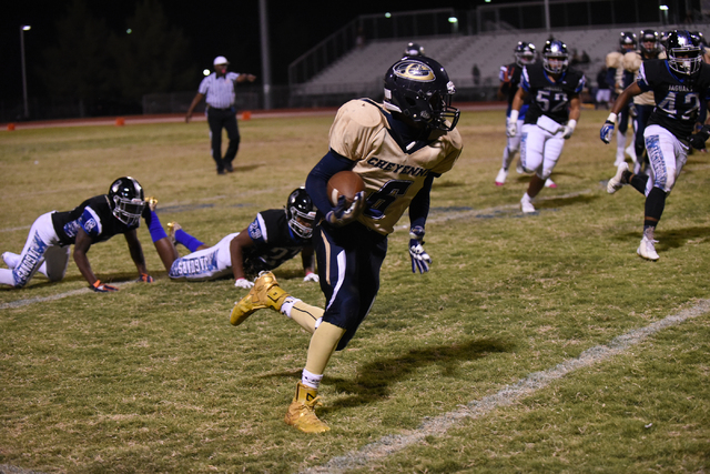 Cheyenne’s Corwin Bush (6) runs the ball against Desert Pines defense during their foo ...