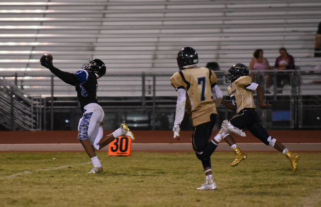 Desert Pines Tony Fields (1) catches the ball against Cheyenne’s defense during their ...