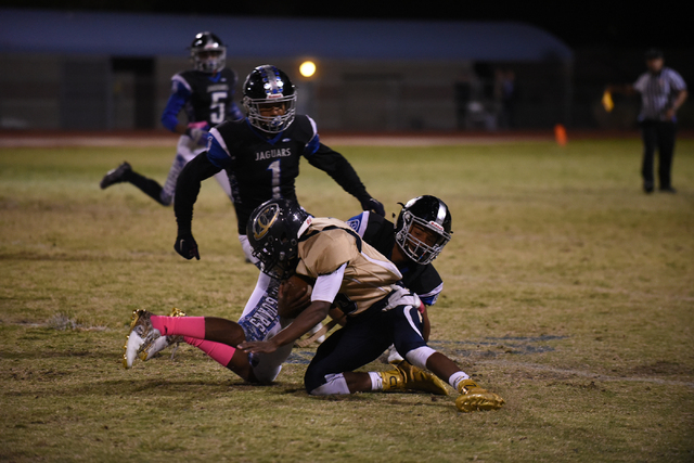 Cheyenne’s Deriontae Green (5) is tackled by the Desert Pines defense during their foo ...