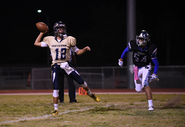 Cheyenne’s Matthew LaBonte (12) throws the ball against Desert Pines Gabriel Lopez (54 ...