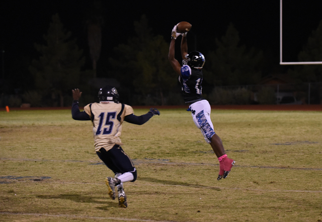 Desert Pines Jordan Simon (12) catches the ball against Cheyenne’s Anthony Walker (15) ...