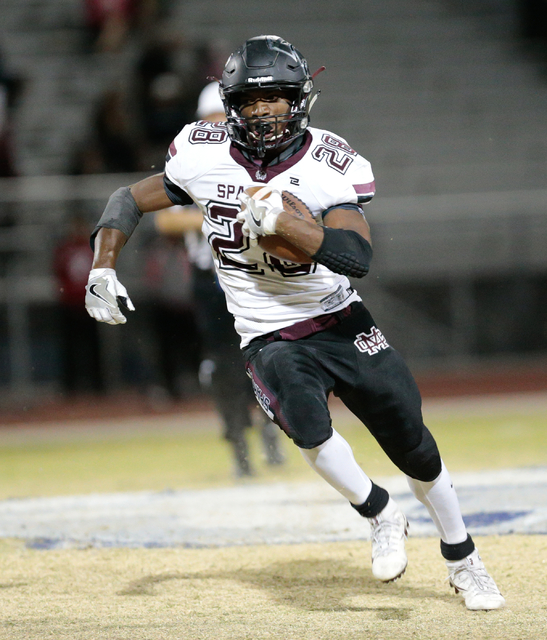 Cimarron-Memorial senior Tyree Riley (28) makes a fast break with the ball during a football ...