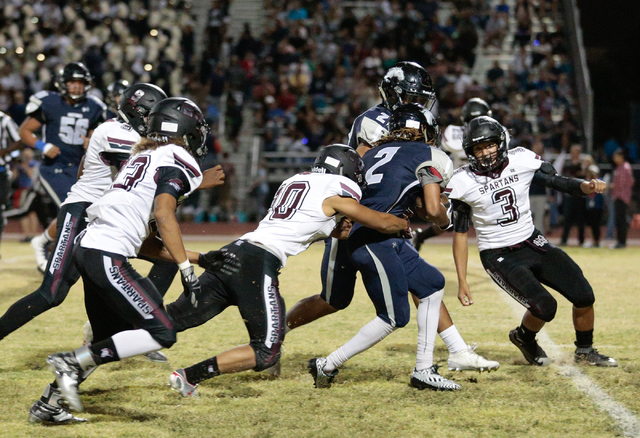 Shadow Ridge junior Elisha Young (2) attempts to break free from Cimarron-Memorial senior Ni ...