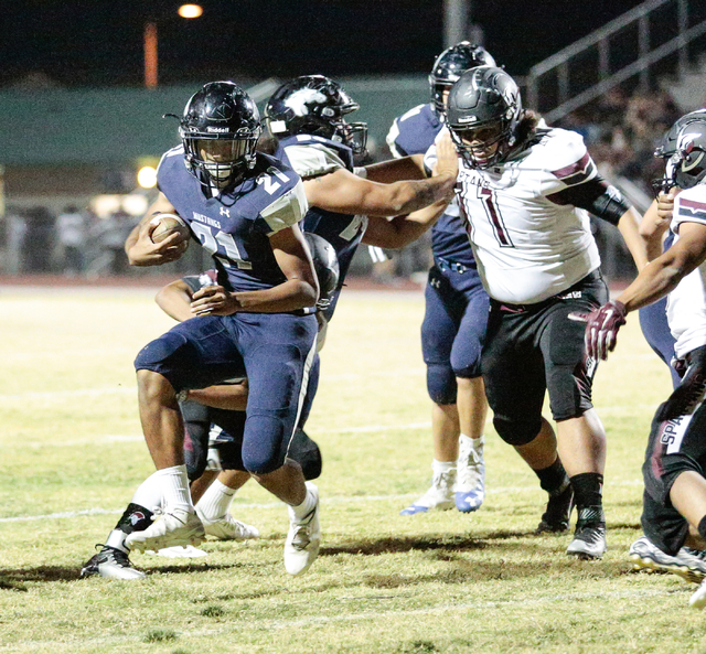 Shadow Ridge junior Kaejin Smith-bejgrowicz (21) runs the ball in for a two point conversion ...