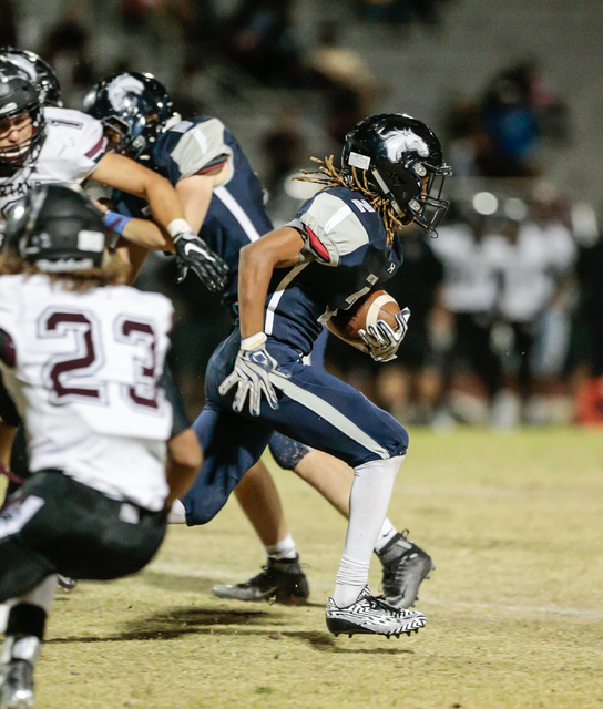 Shadow Ridge junior Elisha Young (2) breaks out and away from defenders while returning a ki ...