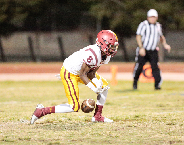 Del Sol sophomore Titan Williams (6) misses a ball, kicked by Desert Pines during the footba ...