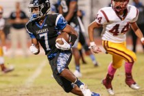 Desert Pines senior Isaiah Morris (7) runs the ball down the field as Del Sol sophomore Ati ...