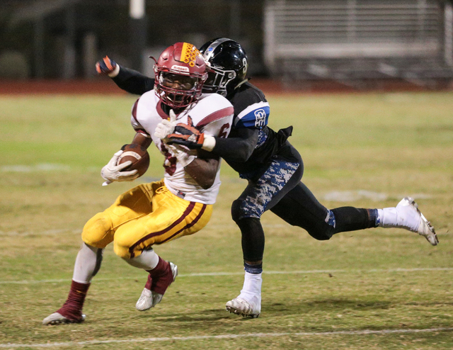 Desert Pines senior Andrew Gray (8) right, prepares to make a tackle on Del Sol sophomore Ti ...