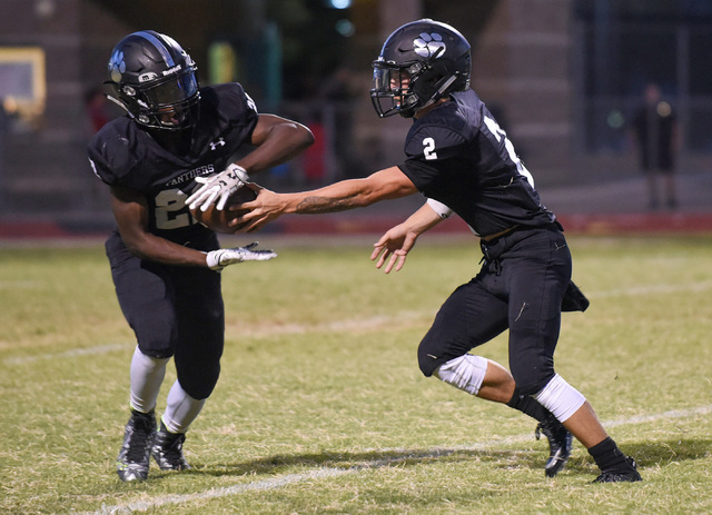 Palo Verde’s Jonathan Schofield (2), right, hands off the football to teammate Chamere ...